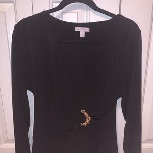 a skin tight black dress with some gold detail